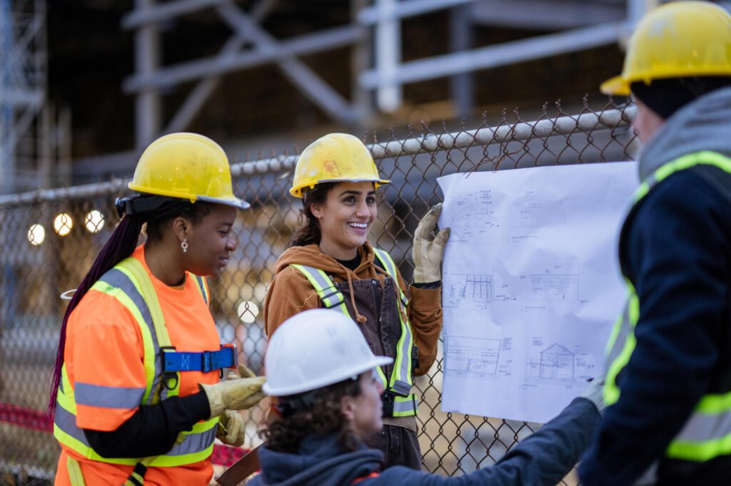 construction workers looking at blueprints