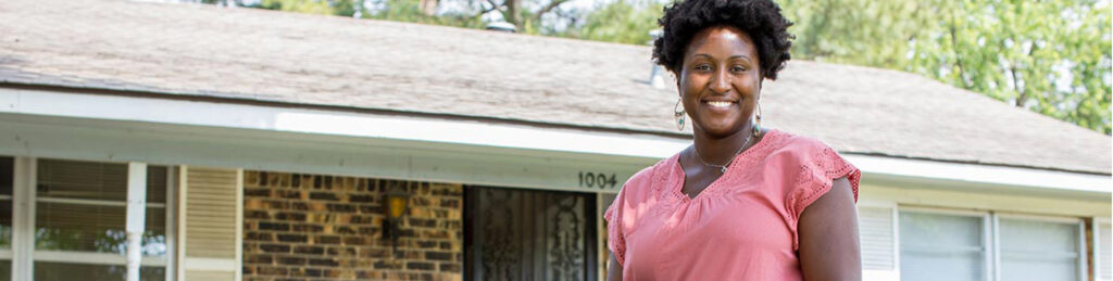 image of black woman in front of a house